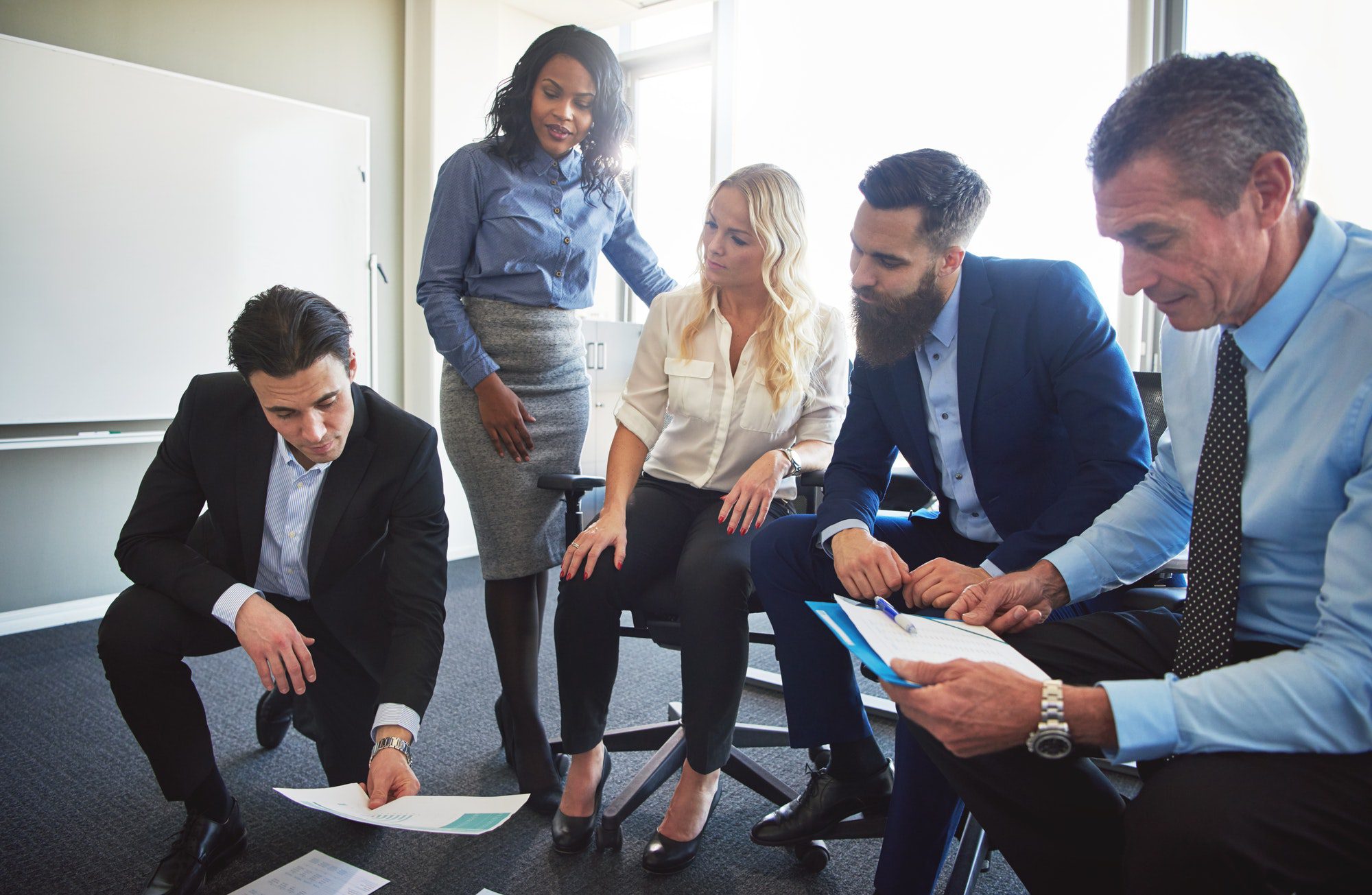 Businesspeople planning and strategizing with paperwork in an office